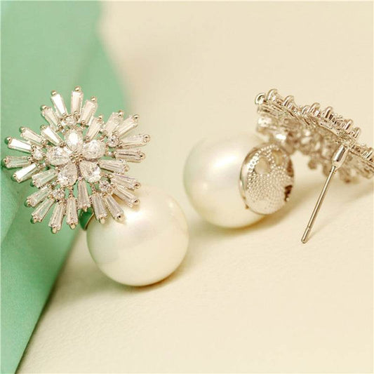 Elegant earrings combining sparkling crystals and classic pearls for timeless beauty.